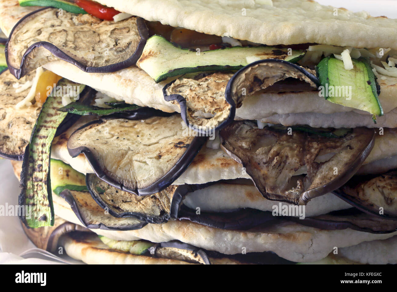 flatbread with grilled eggplant and zucchini on sale in Italian bars