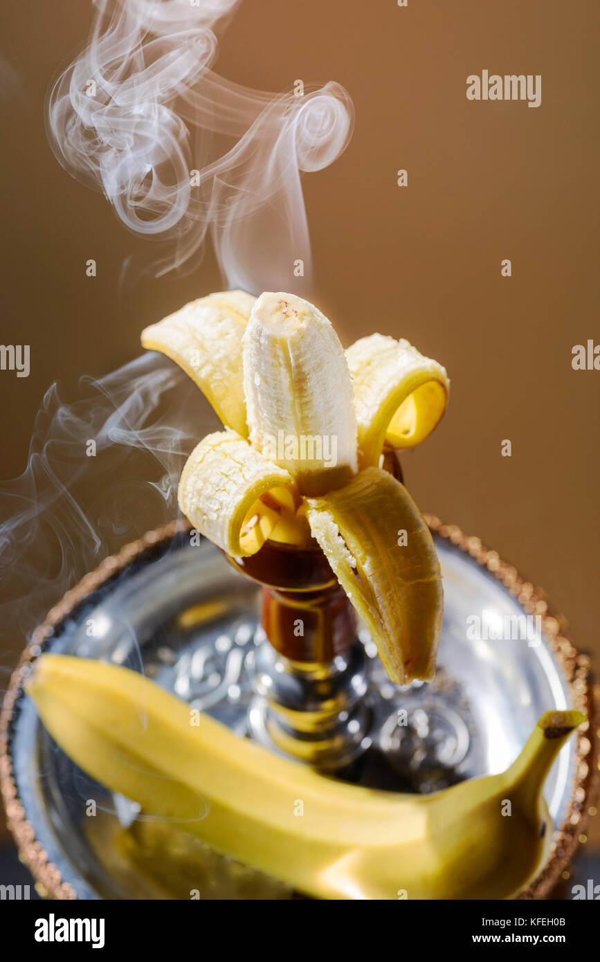 Smoking hookah with fruit head on dark background Stock Photo Alamy