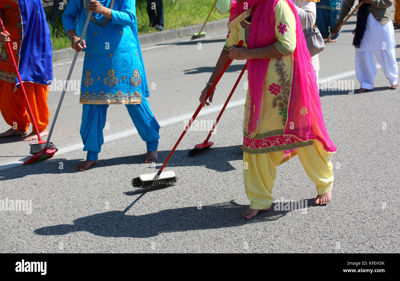 Sikh religion event and the brave women with colorful clothes sweeping