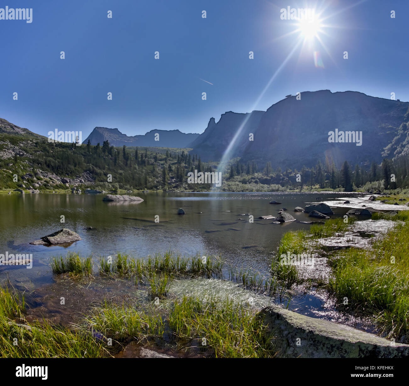 Fantastic sunny day is in mountain lake. Creative collage. Beauty world in the Ergaki national park, Russia Stock Photo