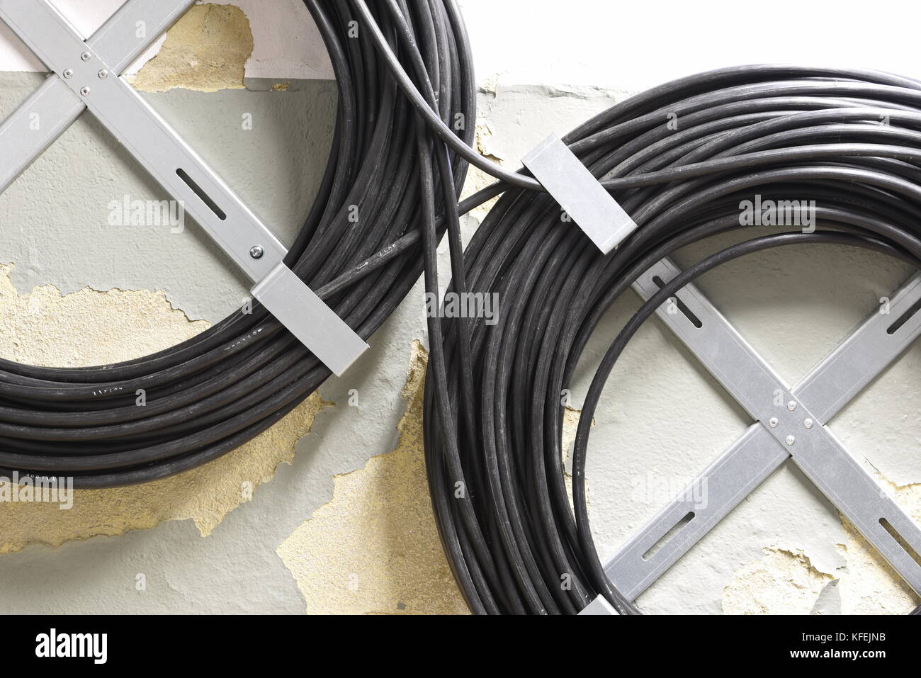 Telecommunication cable reserve on the wall Stock Photo