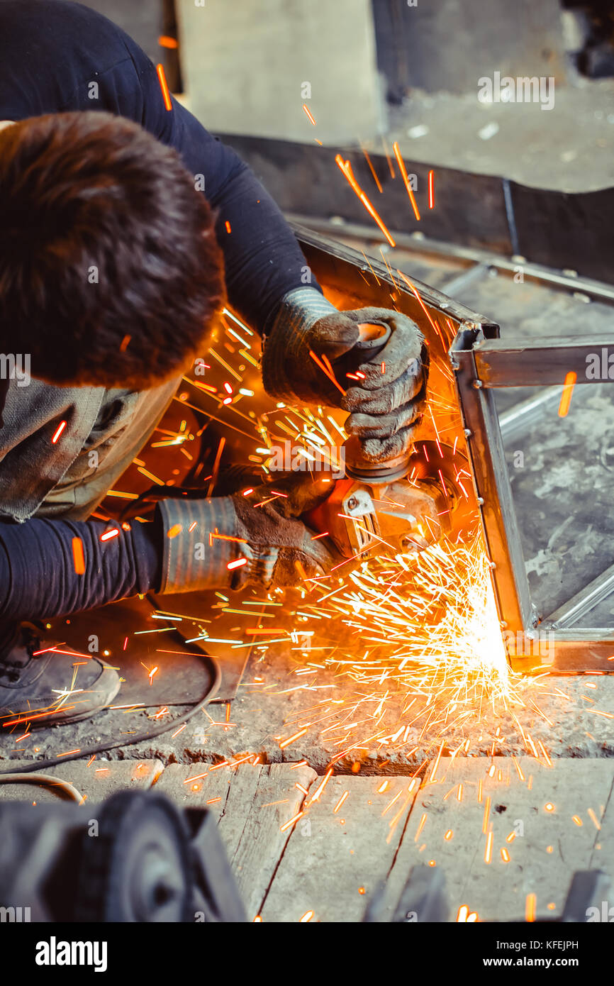 worker sawing metal with a saw, sparks fly Stock Photo Alamy