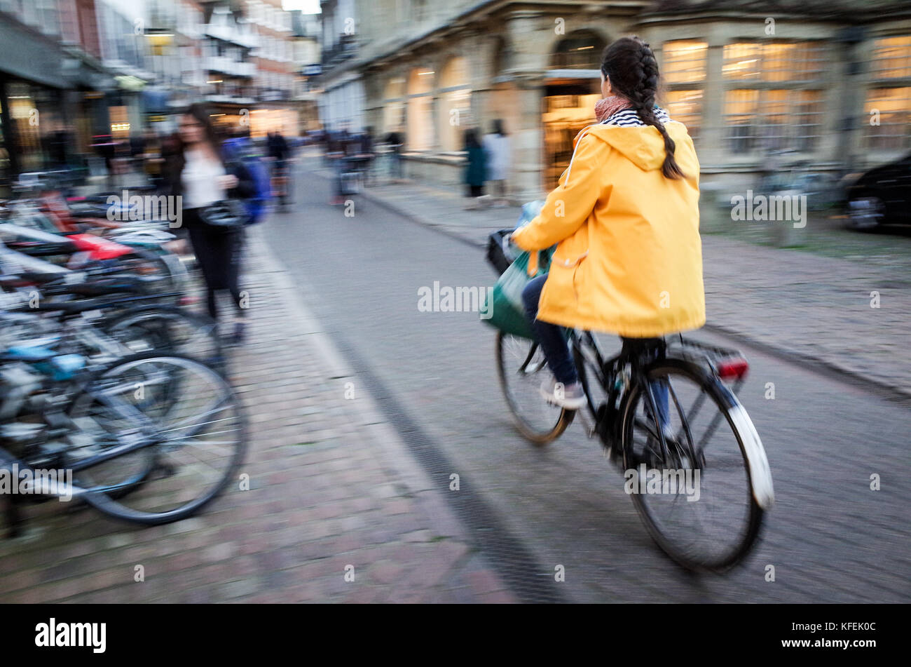 Student and Commuters cycle through the streets of the historic city centre of Cambridge UK Stock Photo