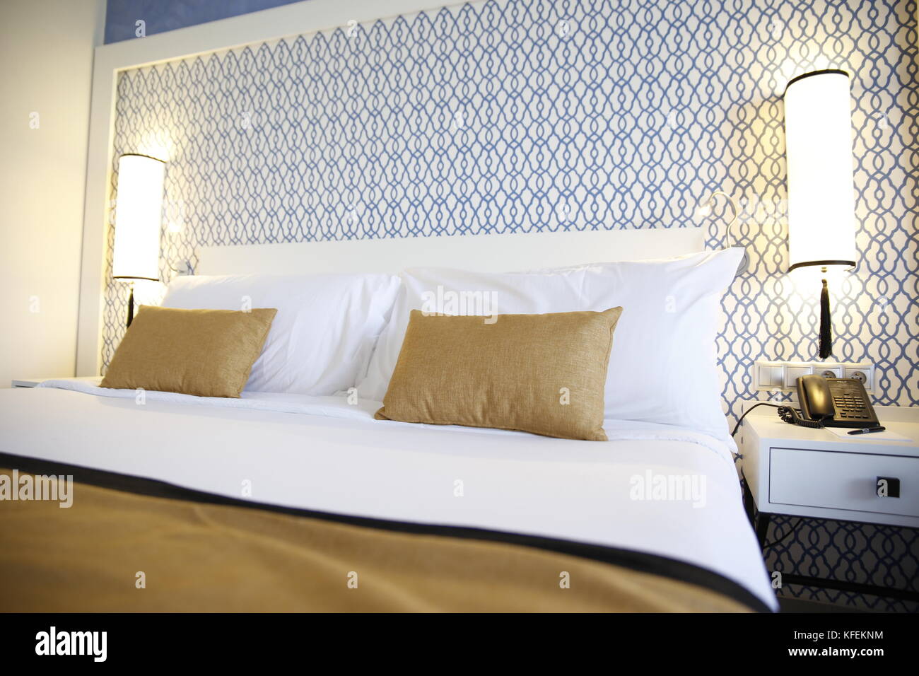 Hotel bedroom, double bed and pillows, blue patterns bedhead,  saidia, Morocco Stock Photo