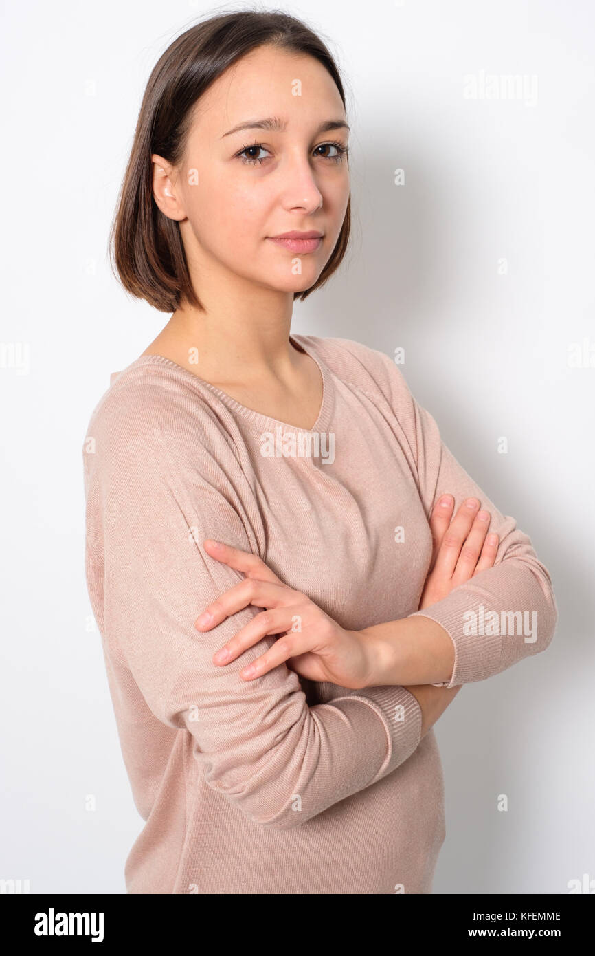 Portrait of serious woman with arm crossed isolated on background Stock Photo