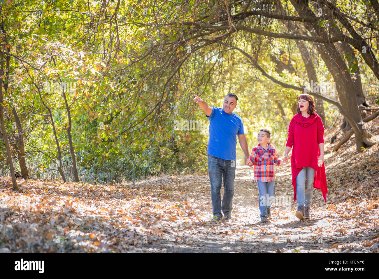 Mixed Race Caucasian and Hispanic Family Taking a Walk At The Park ...