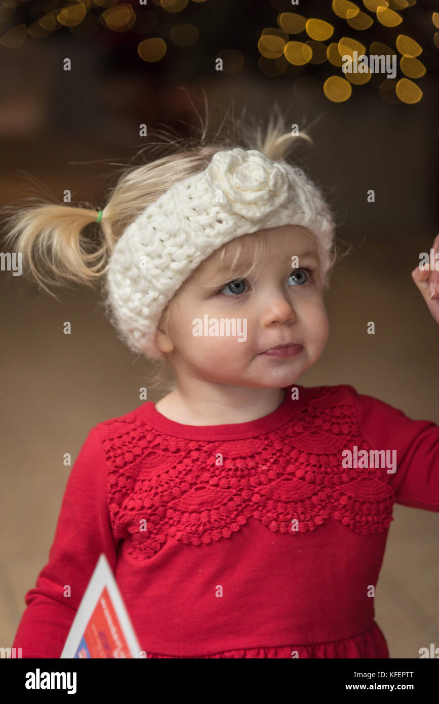 Little girl in knit dress and headband at Christmas Stock Photo Alamy