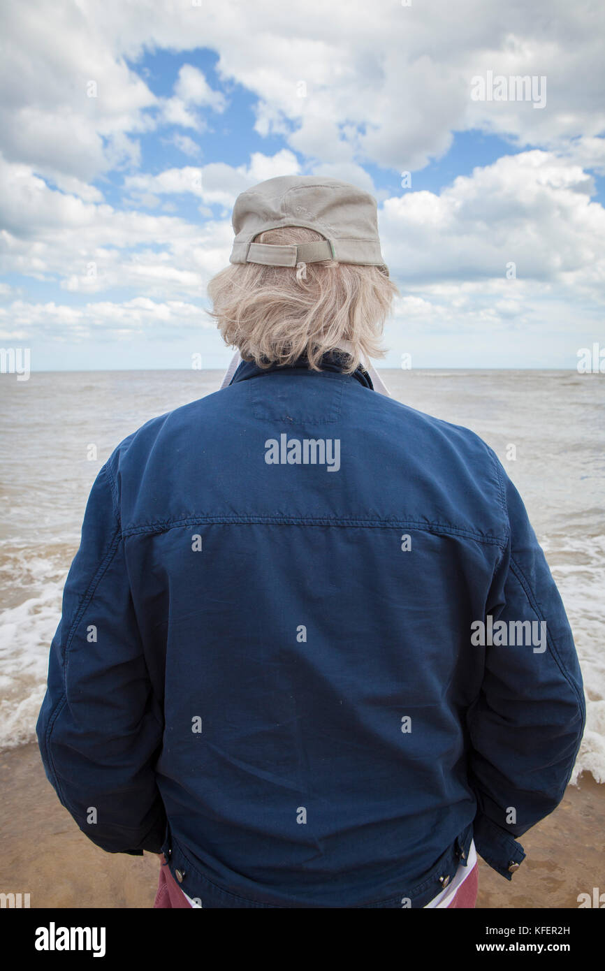 Mature man looking out to sea Stock Photo
