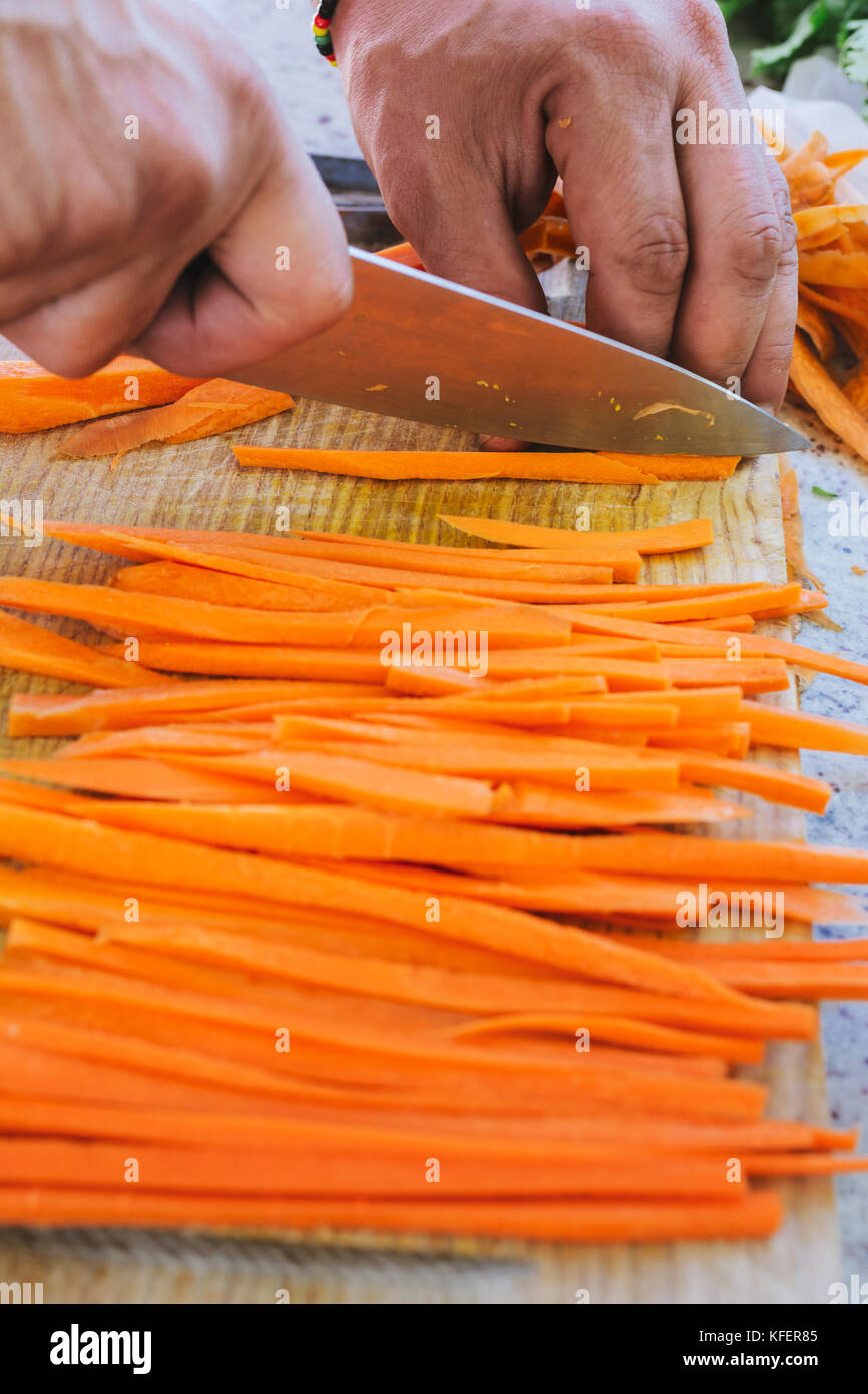 man's hands, cut carrot julienne style, in the kitchen Stock Photo - Alamy