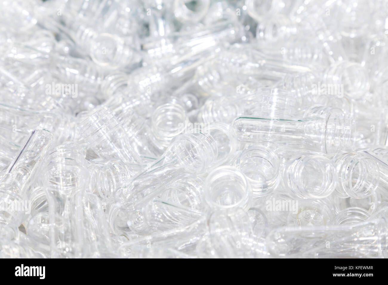 group of transparent plastic PET preform ready to go in the line of production for the plastic bottle machine in the plastic bottle factory, industria Stock Photo