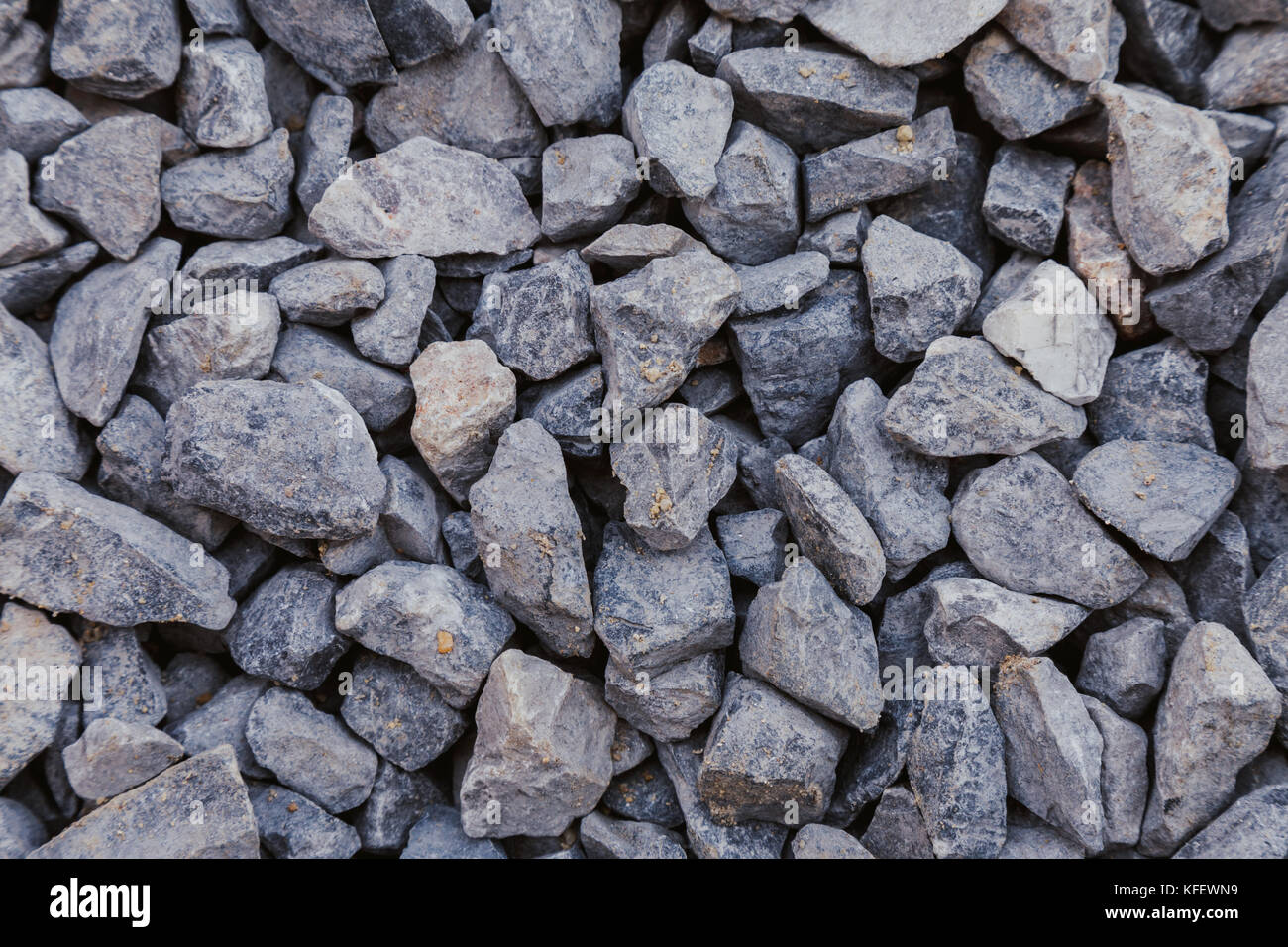 close up of gray crushed rock, stone raw material for construction