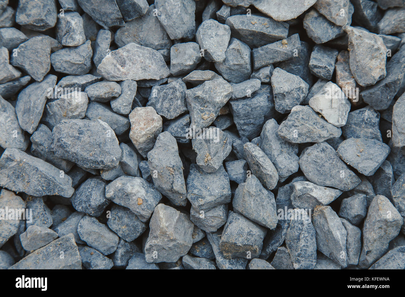 close up of gray crushed rock, stone raw material for construction industry. background and texture. Stock Photo