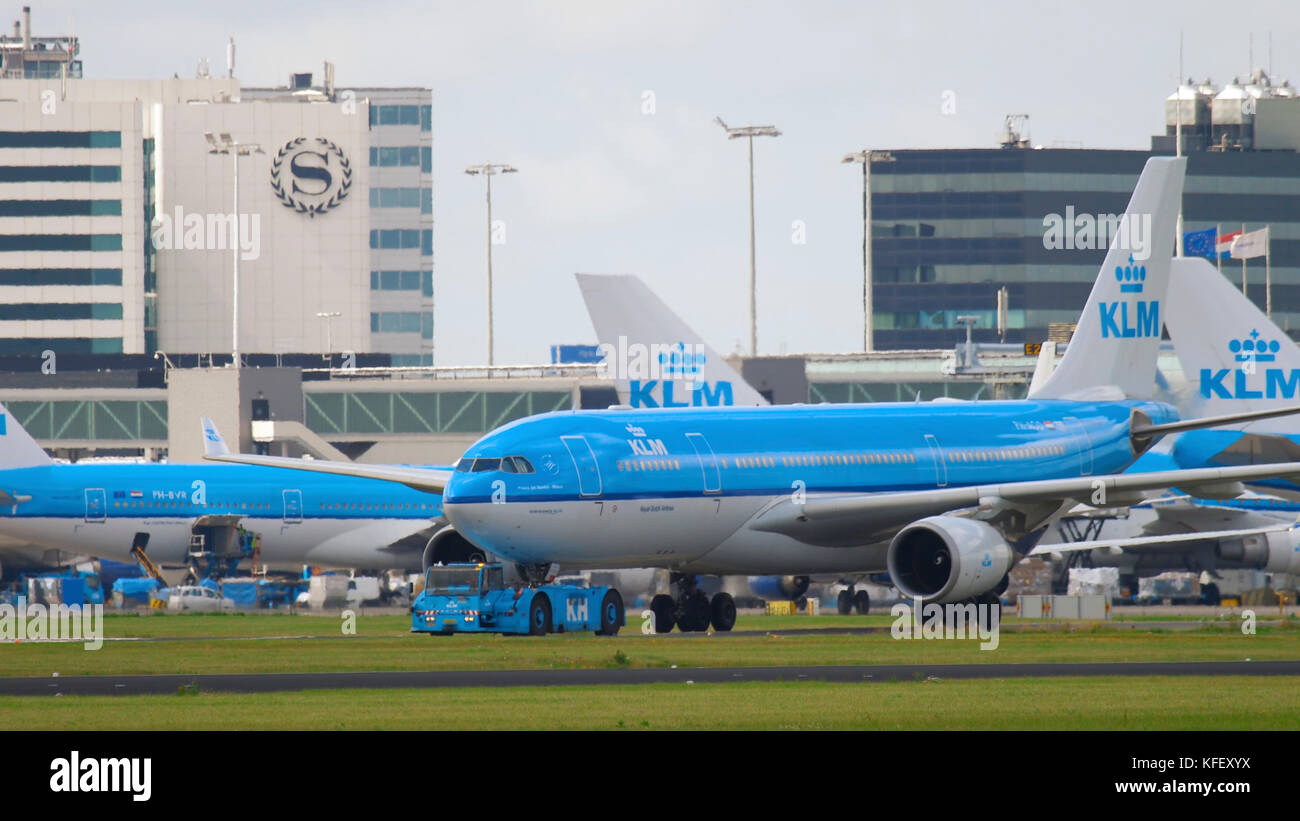AMSTERDAM, THE NETHERLANDS - JULY 26, 2017:  KLM Airbus 330 PH-AOD towing by tractor to service. Shiphol Arport, Amsterdam, Holland Stock Photo