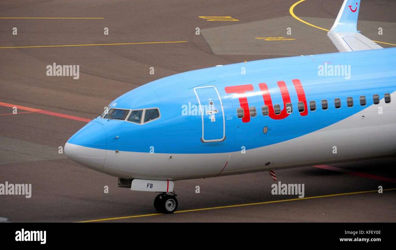 AMSTERDAM, THE NETHERLANDS - JULY 29, 2017:  TUI Fly Boeing 737  PH-TFB taxiing ends after landing. Shiphol Airport, Amsterdam, Holland Stock Photo