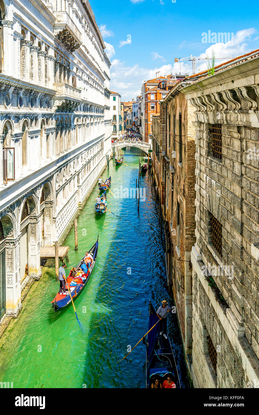 A busy canal with tourists in gondolas, as viewed from the Bridge of Sigh's within the Doge's Palace in Venice, Italy Stock Photo