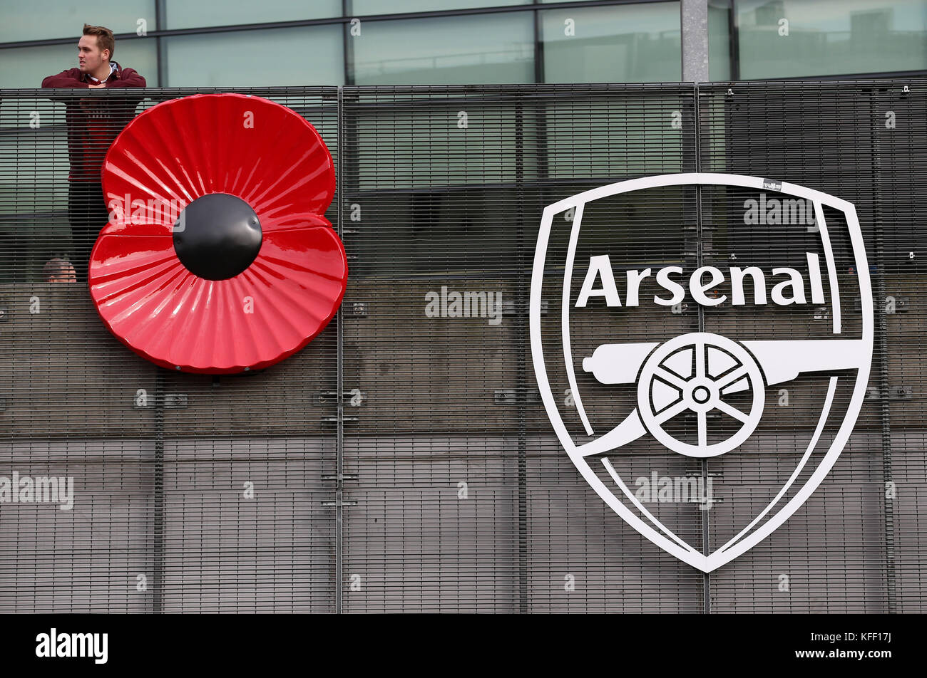 A giant poppy next to an Arsenal logo during the Premier League match at  the Emirates Stadium, London Stock Photo - Alamy, image size:1300x952