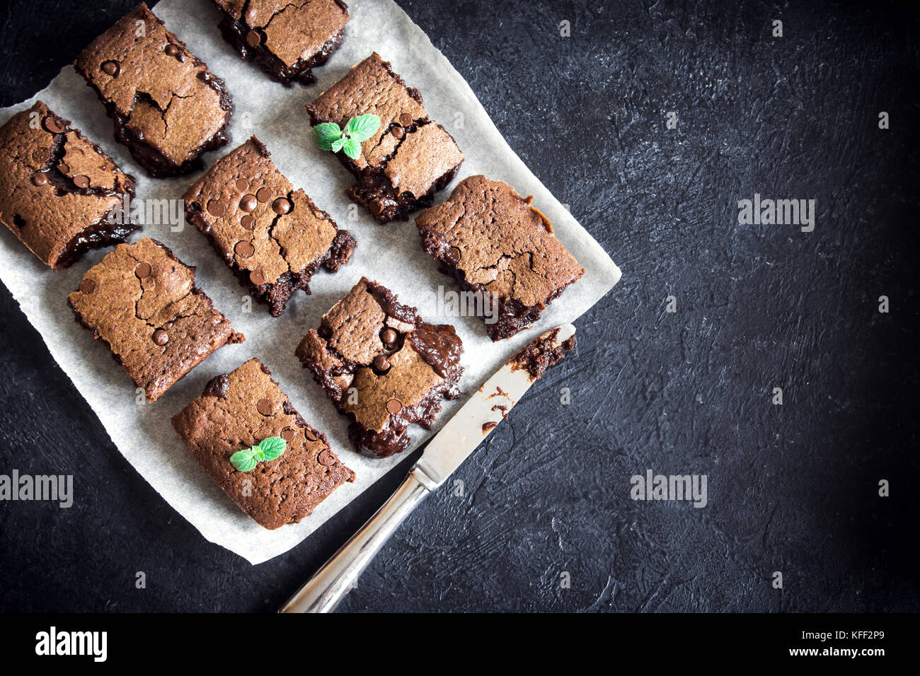 Brownies. Homemade chocolate fudge brownies on rustic black background, top view. Stock Photo