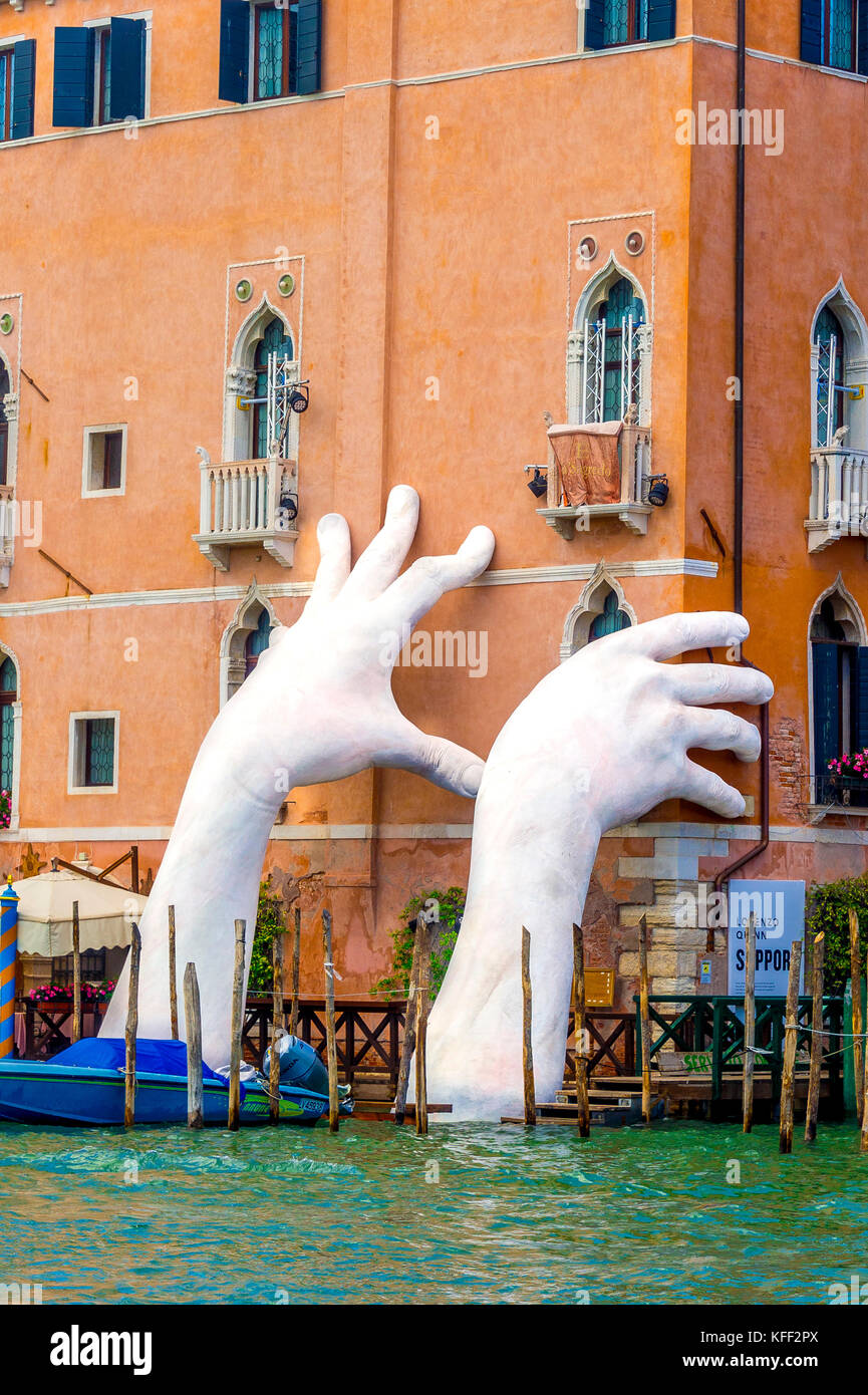 A sculpture of giant white hands by artist Lorenzo Quinn to highlight the devastation of climate change during 2017 Biennale in Venice, Italy. Stock Photo