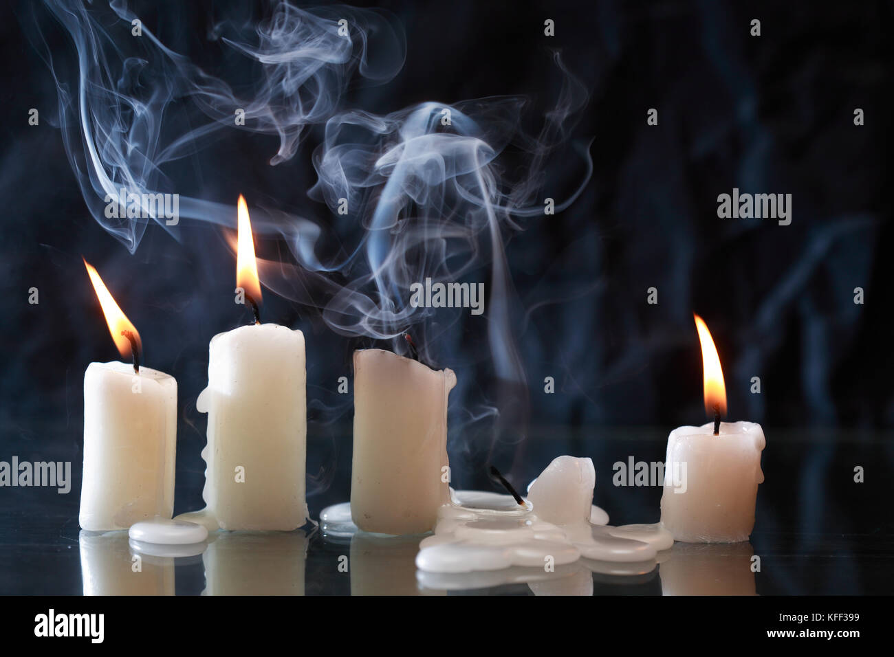 Set of lighting candles with fire and smoke on nice dark background Stock Photo Alamy
