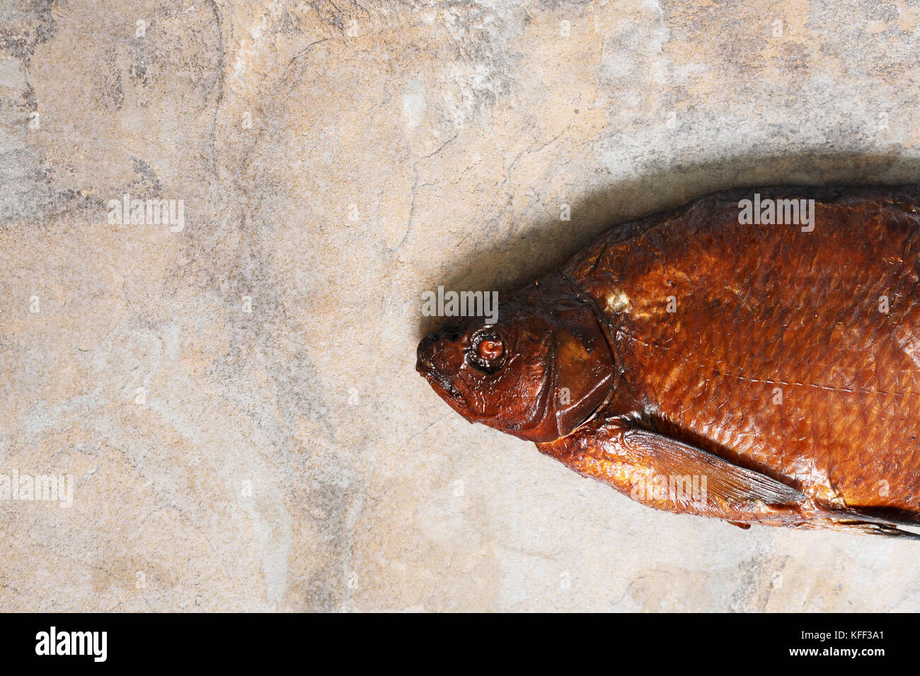 Closeup of one freshness smoked bream on stone background with free