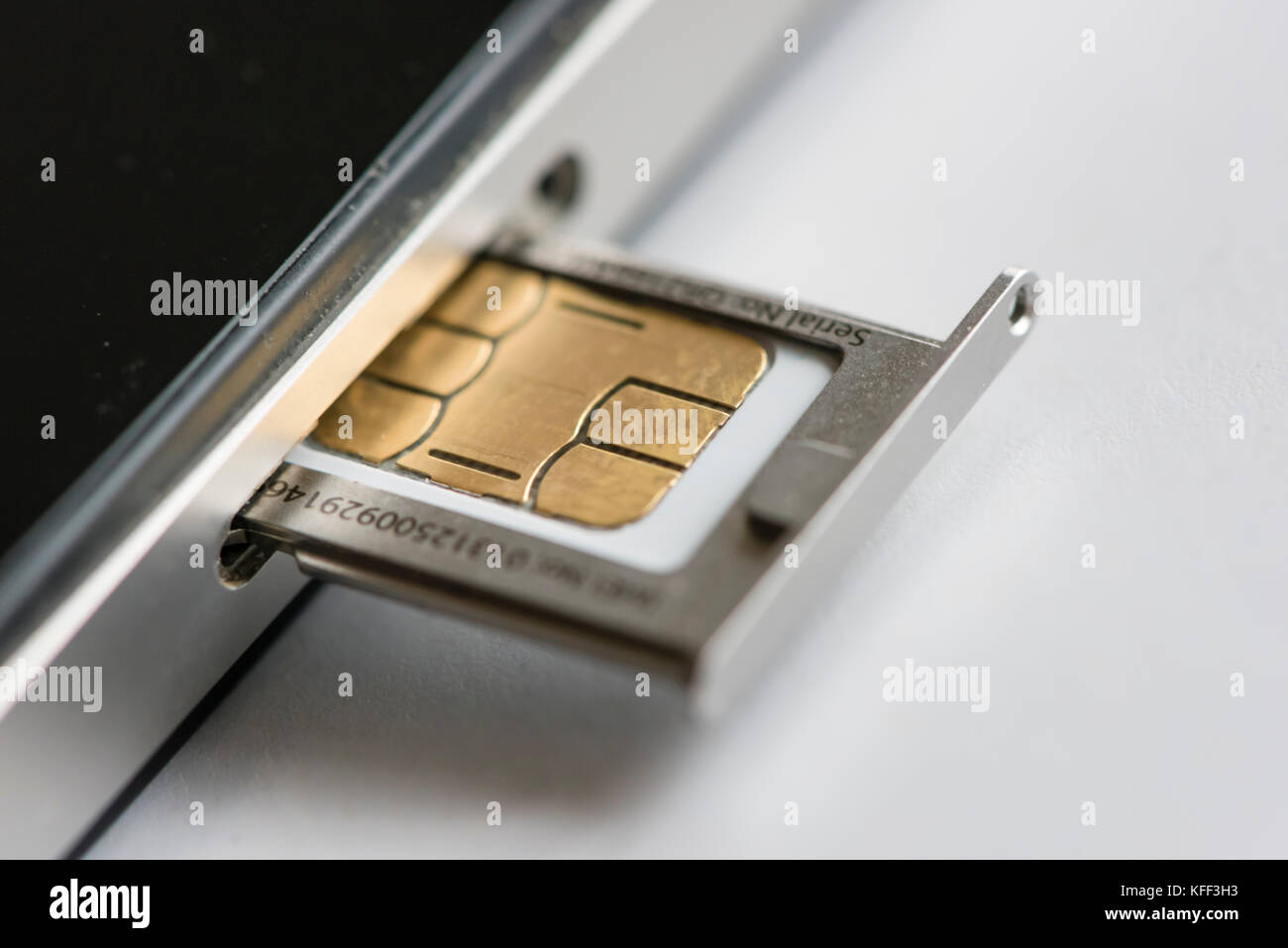 A micro SIM-card is inserted into an Apple iphone 4 smartphone. The SIM  (Subscriber Identity Module) card holds security keys to identify and  authenti Stock Photo - Alamy