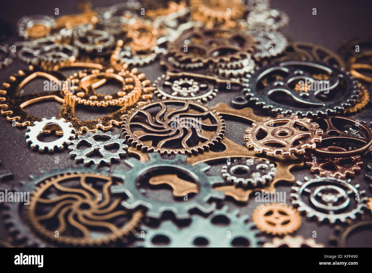 Assorted metal gears on gray background , selective focus Stock Photo