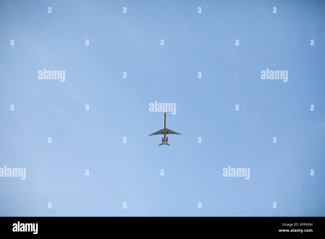small airplane on blue sky negative space Stock Photo