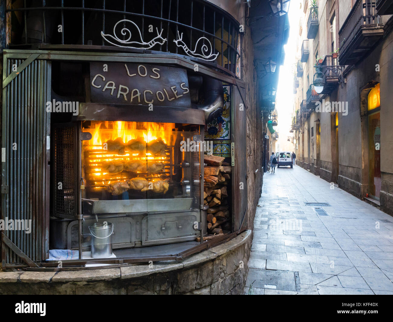 Barcelona, Spain - 11 Nov 2016: Chicken on a spit are rotating on the rotisserie grill of Barcelona's famous restaurant 'Los Caracoles'. Stock Photo