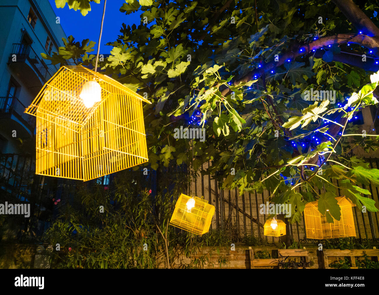 Barcelona, Spain - 11 Nov 2016: Illuiminated bird cages as decoration at an outdoor restaurant in Barcelona. Stock Photo