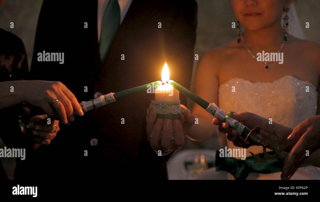 Light the candle. Two women light the big candle. Light the candle on a