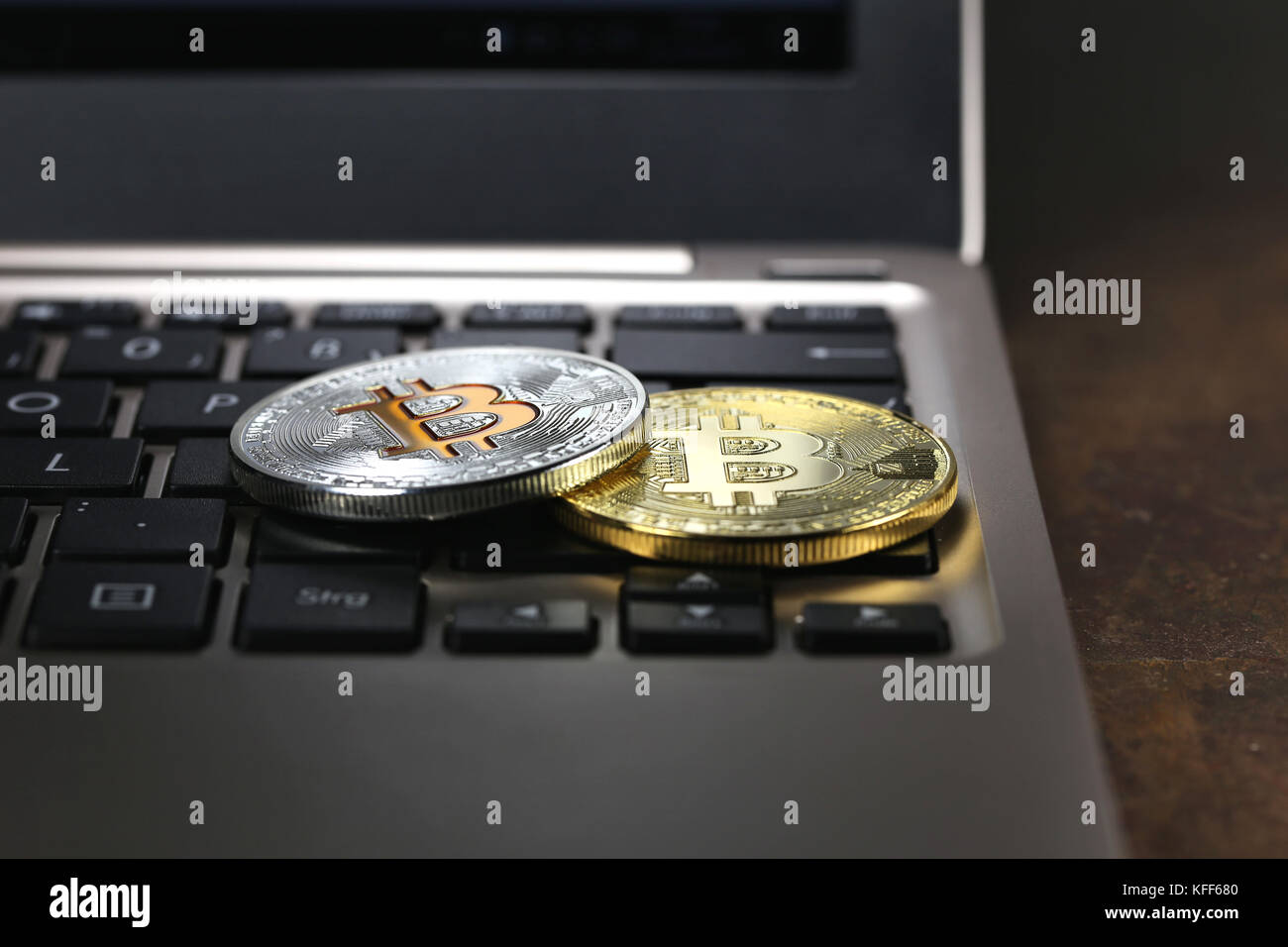 Bitcoins on a laptop keyboard Stock Photo