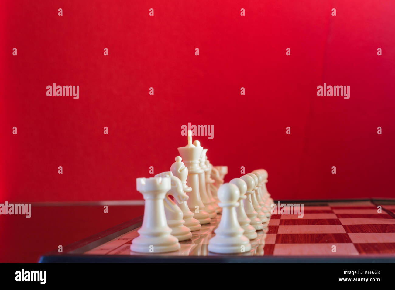 Chess white seen in plan and cut with red background Stock Photo - Alamy