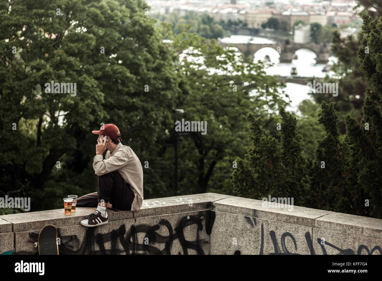 Young man talking on the phone, enjoying at Letna park above Vltava River Prague Czech Republic Stock Photo