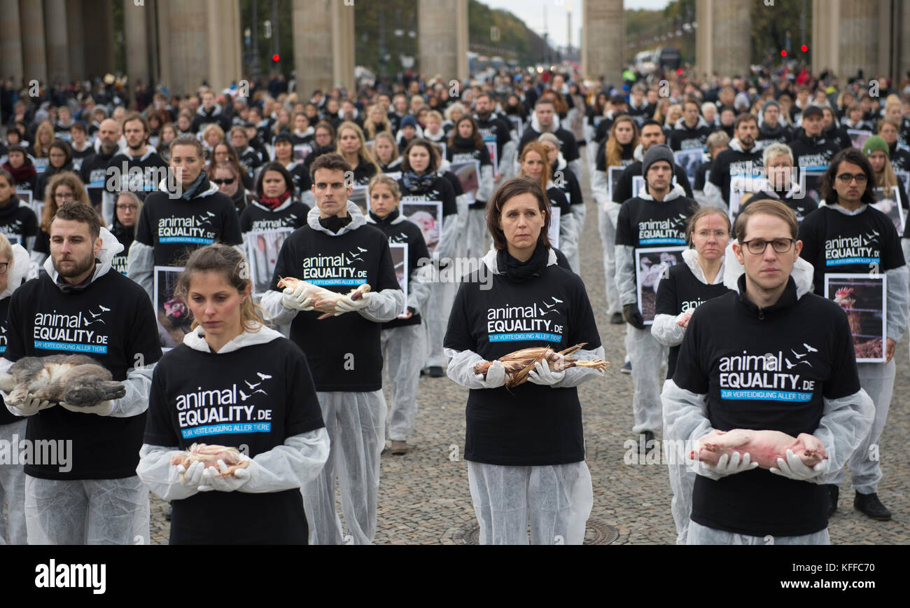 Animal rights activists from the group Animal Equality hold dead animals in their hands during a silent protest in front of the Brandenburg Gate in central Berlin, Germany, 28 October 2017. Around Animal rights activists from the group Animal Equality hold dead animals in their hands during a silent protest in front of the Brandenburg Gate in central Berlin, Germany, 28 October 2017. Around