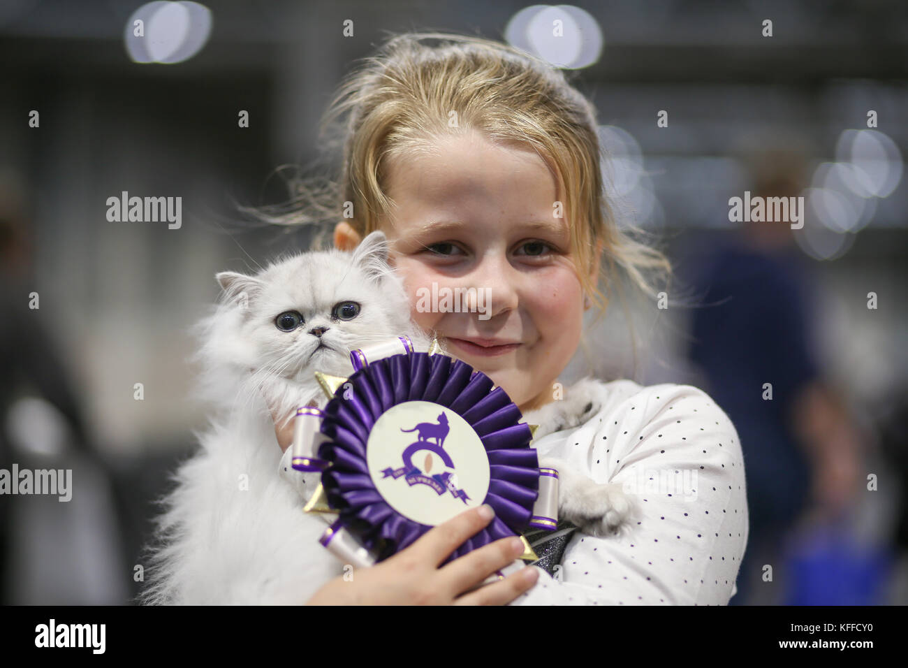 Birmingham, UK. 28th October 2017. Cats and their owners descend on the NEC to show their pedigree bred cats. 8-year-old Nicole Gibson with her prize-winning kitten Emporiums Starlight.   Peter Lopeman/Alamy Live News Stock Photo