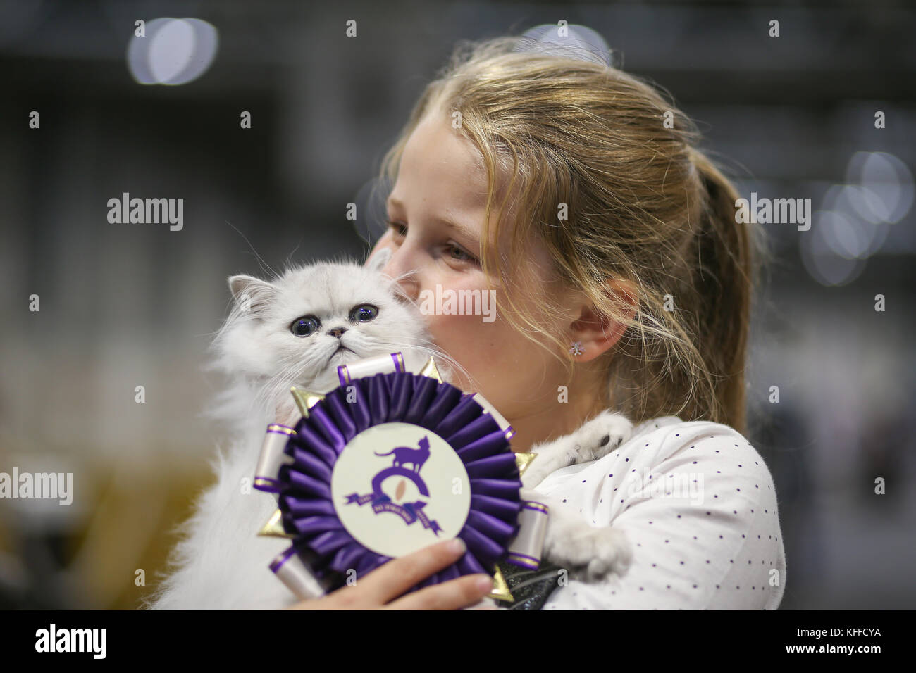 Birmingham, UK. 28th October 2017. Cats and their owners descend on the NEC to show their pedigree bred cats. 8-year-old Nicole Gibson with her prize-winning kitten Emporiums Starlight.   Peter Lopeman/Alamy Live News Stock Photo