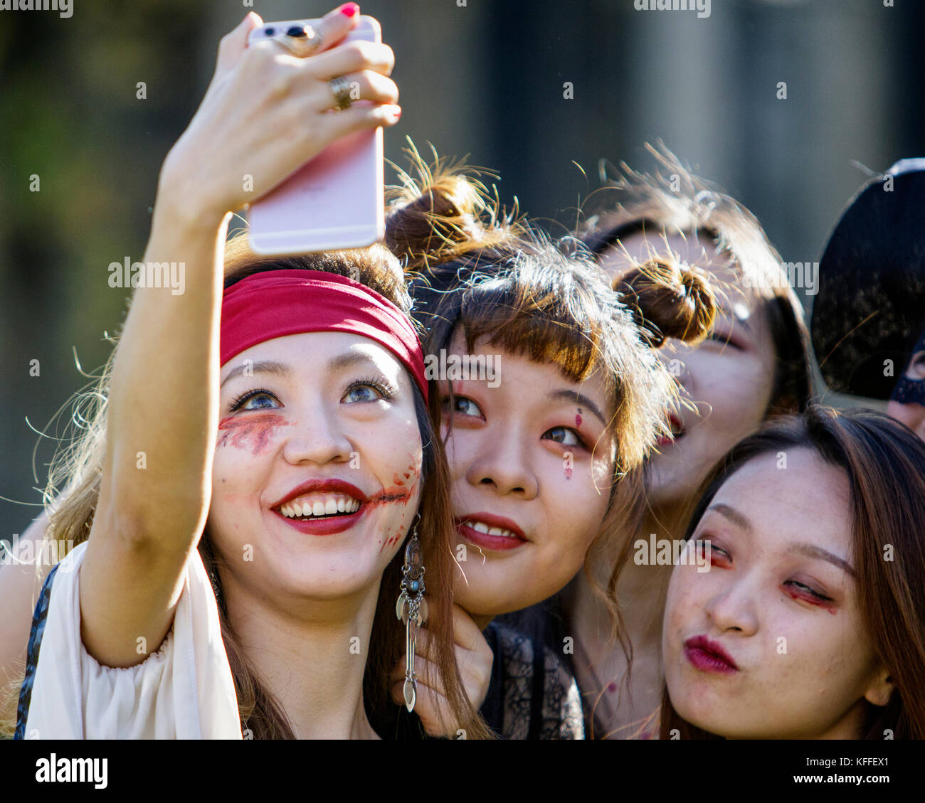 Bristol, UK. 28th Oct, 2017. A group of women dressed as zombies and taking part in a zombie walk through the city centre are pictured as they pose for a selfie. Stock Photo
