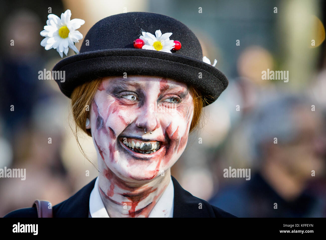 Bristol, UK. 28th Oct, 2017. A woman with a painted face, make up and dressed as a zombie is pictured as she participates in a Zombie Walk In Bristol. Stock Photo