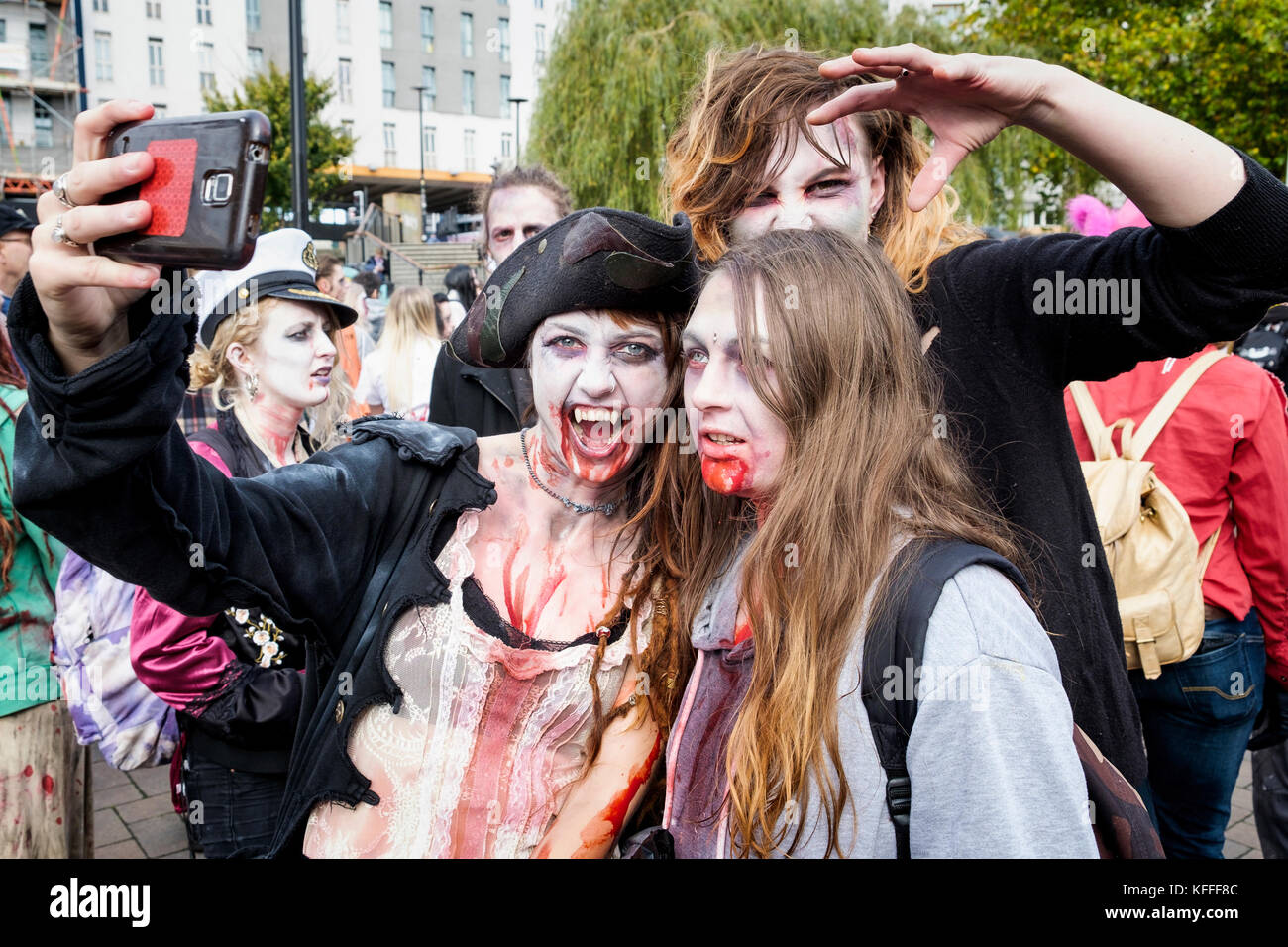Bristol, UK. 28th Oct, 2017. A group of people dressed as zombies and taking part in a zombie walk through the city centre are pictured as they pose for a selfie. Stock Photo
