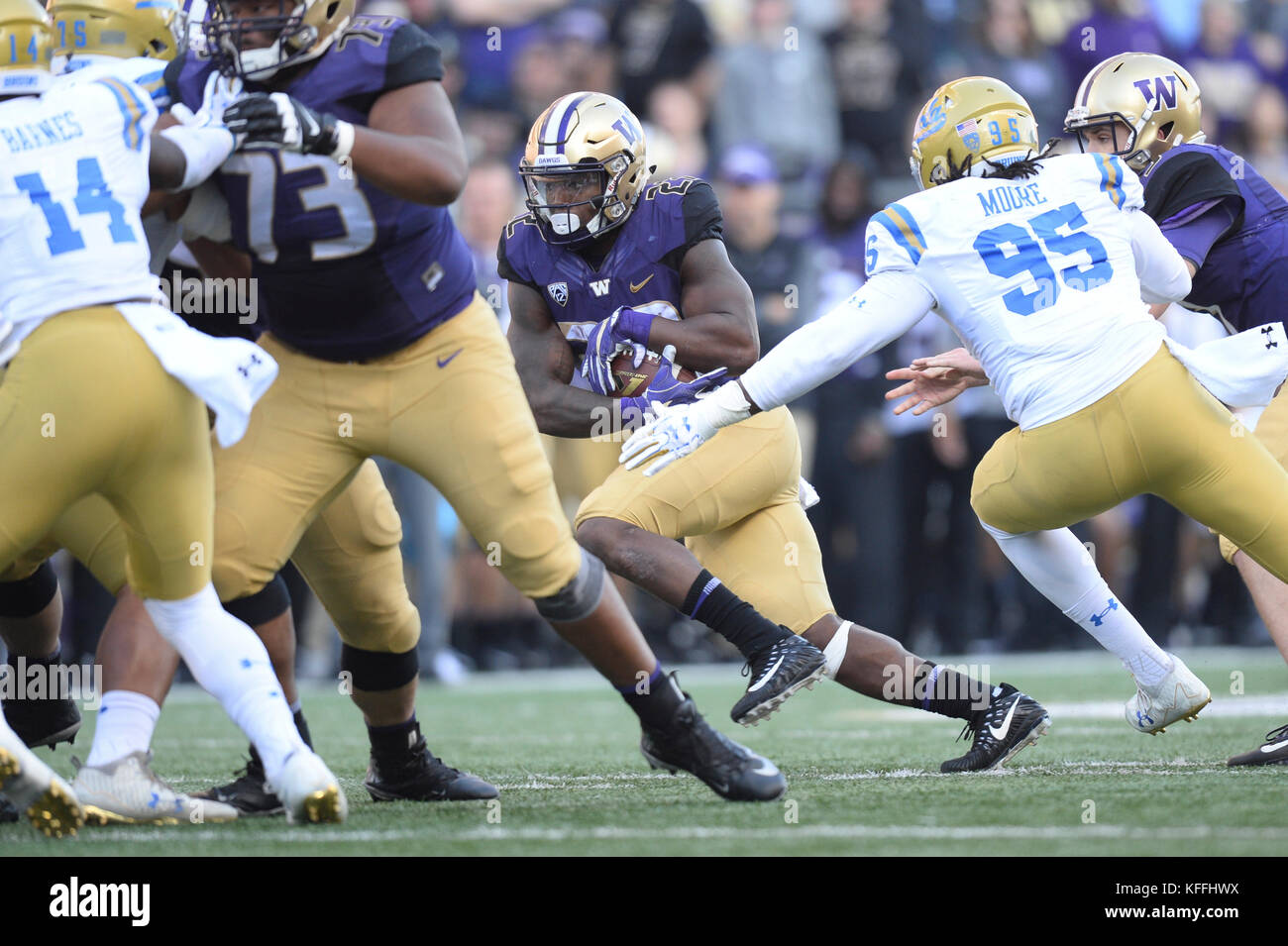 Seattle, WA, USA. 28th Oct, 2017. UCLA lineman Marcus Moore (95) puts pressure on UW tailback Myles Gaskin (9) during a PAC12 football game between the UCLA Bruins and the Washington Huskies. The game was played at Husky Stadium on the University of Washington campus in Seattle, WA. Jeff Halstead/CSM/Alamy Live News Stock Photo