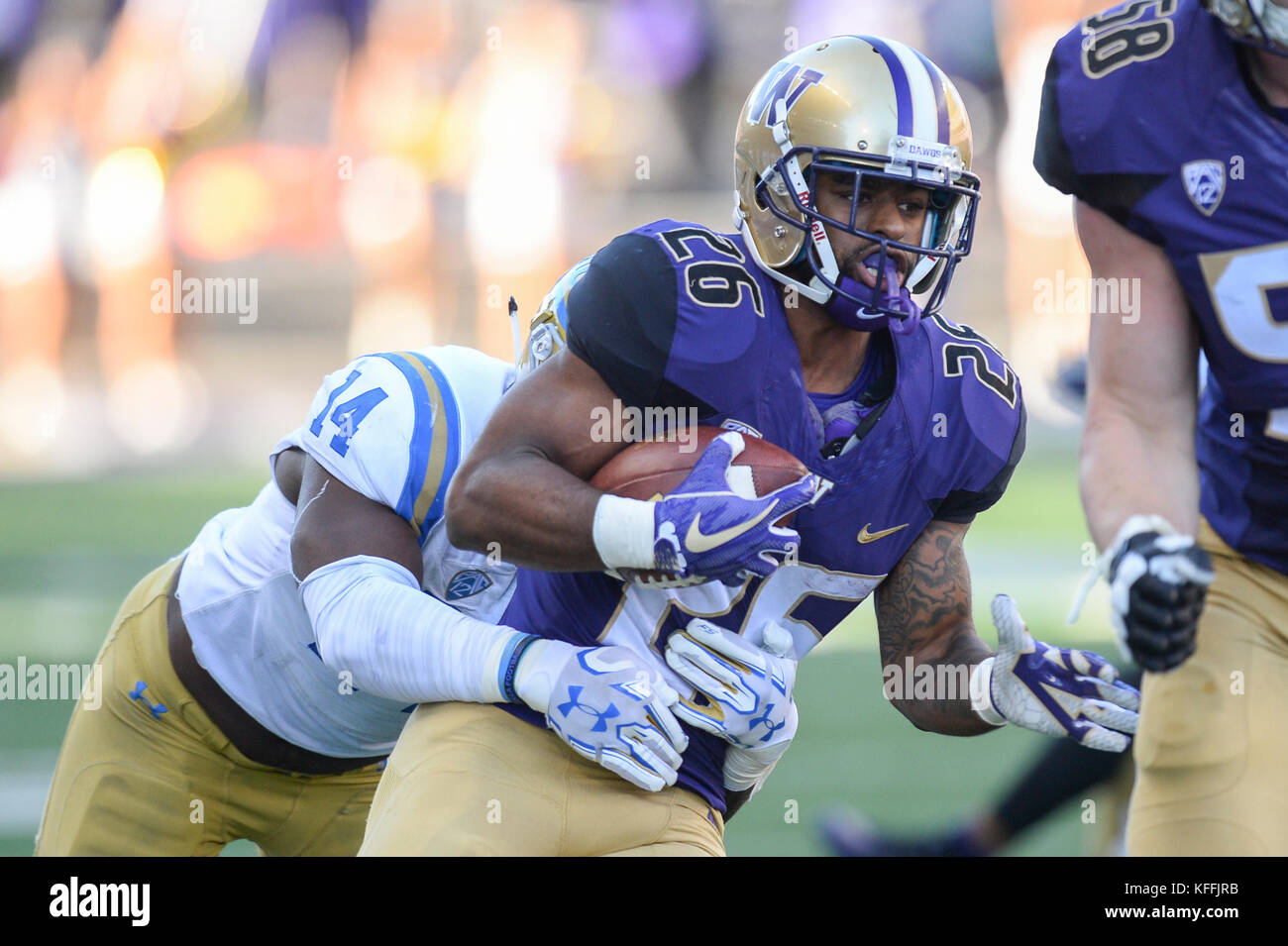Seattle, WA, USA. 28th Oct, 2017. UW running back Salvon Ahmed (26) is tackled by UCLA's Krys Barnes (14) after a short gain during a PAC12 football game between the UCLA Bruins and the Washington Huskies. The game was played at Husky Stadium on the University of Washington campus in Seattle, WA. Jeff Halstead/CSM/Alamy Live News Stock Photo