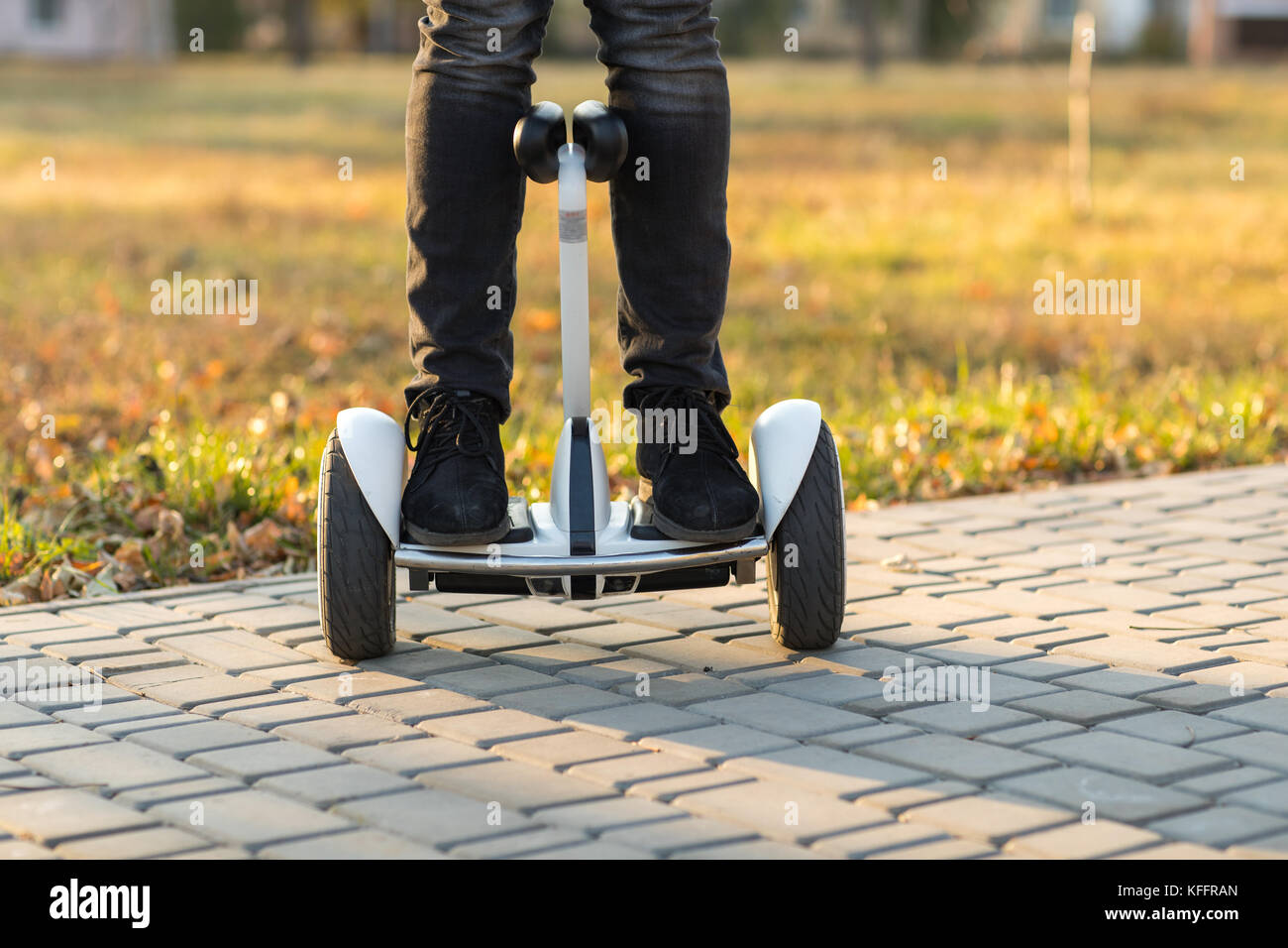 Male legs on electrical scooter outdoors gyro scooter Stock Photo