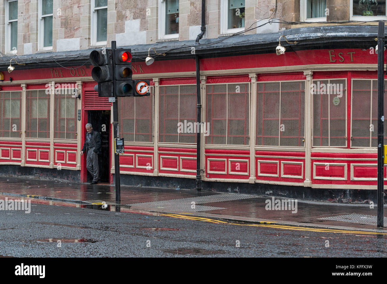 Person outside The Old Ship Bank pub, Glasgow, Scotland Stock Photo