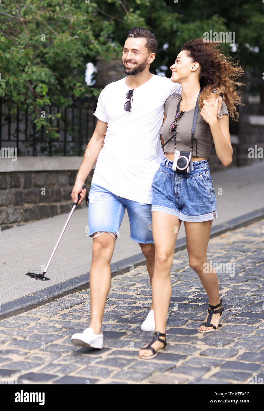 Happy young couple walking in the summer park Stock Photo - Alamy