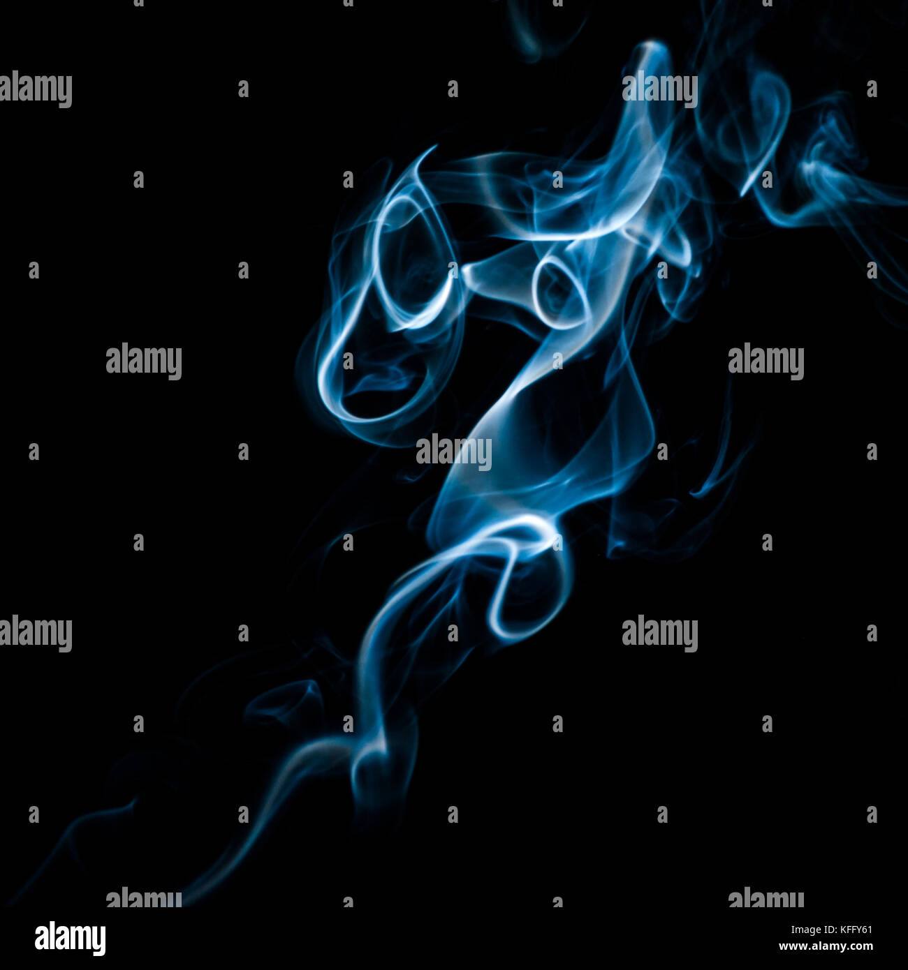 The abstract pattern made from smoke rising from an incense stick. Stock Photo