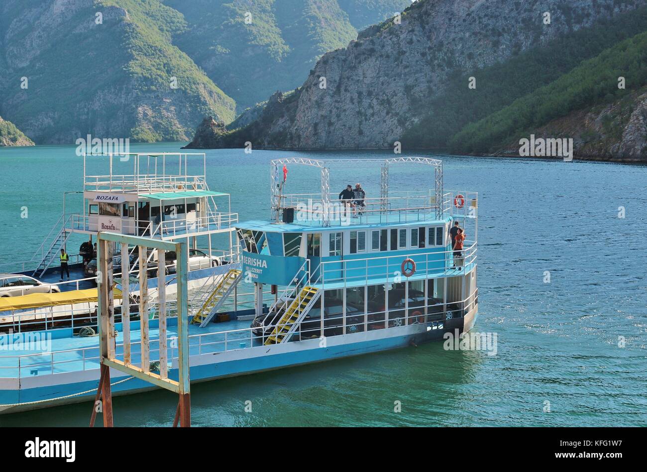 Ferries in the harbor of Koman, on Komani lake, 35 km long. A fascinating mountain world around. North Albania, Southeast Europe. Stock Photo