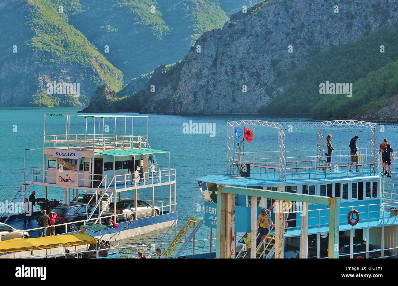 Ferries in the harbor of Koman, on Komani lake, 35 km long. A fascinating mountain world around. North Albania, Southeast Europe. Stock Photo