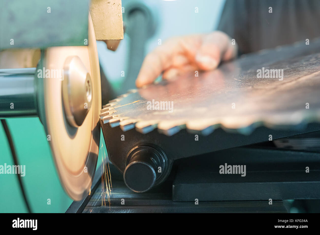 Sharpening Circular Saw, worker sharpens a circular saw blade Stock