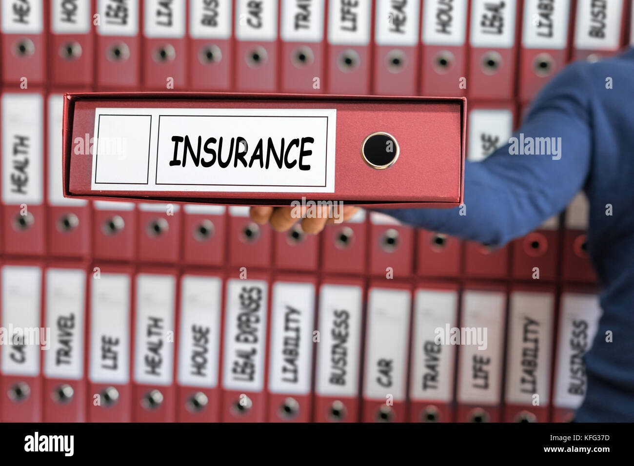 Insurance concept, risk management. Young man holding ring binder Stock
