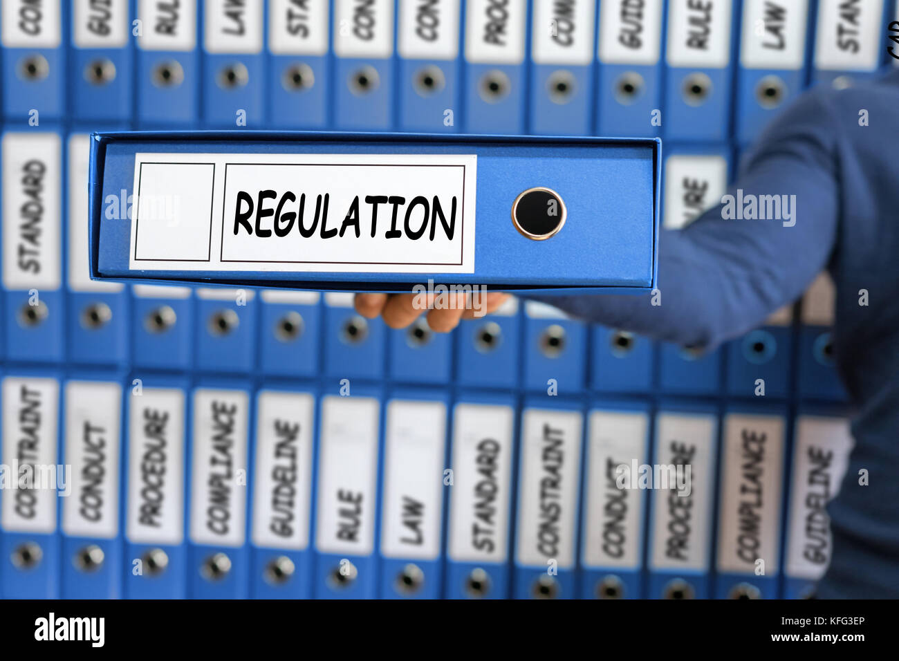 Regulation Business Concept. Young man holding ring binder. Stock Photo